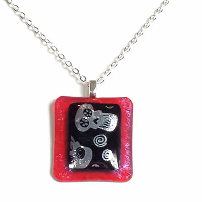 Dichroic skulls on red fused glass necklace