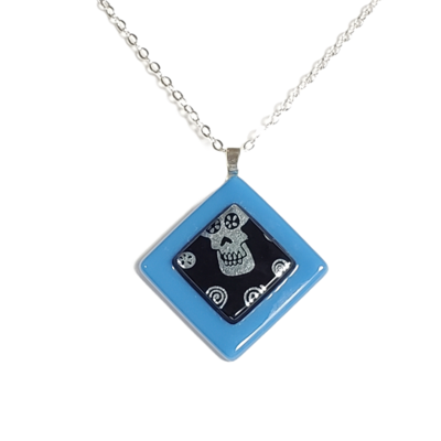 Dichroic sugar skulls on blue fused glass pendant necklace